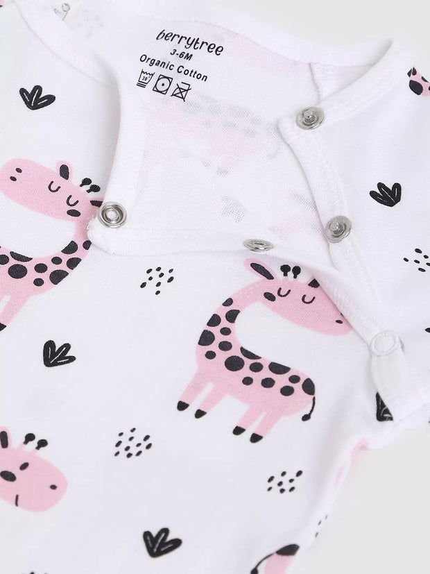 Baby onesie with pink giraffe design and organic cotton label on a white background