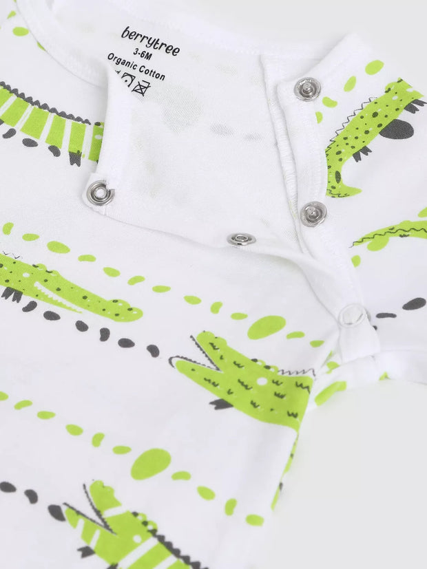 Baby romper with green and black crocodile pattern on a white background