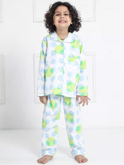 Child wearing a colorful polka dot pajama set against a white background