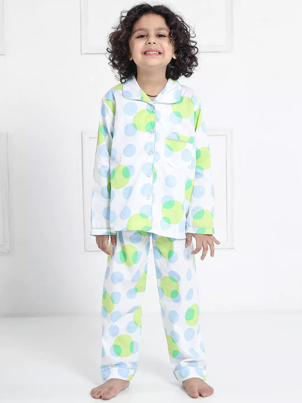 Child wearing a colorful polka dot pajama set against a white background