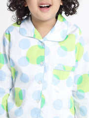 Child wearing a colorful polka dot shirt with a white background