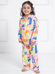 Child wearing a colorful geometric patterned onesie against a white background