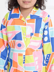Child wearing a colorful geometric patterned shirt against a white background