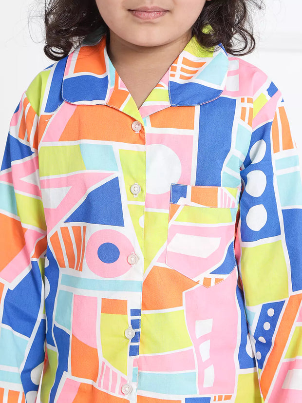 Child wearing a colorful geometric patterned shirt against a white background