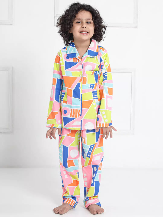 Child wearing colorful geometric patterned pajamas on a white background