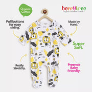 Baby onesie with yellow and black patterns on a white background, featuring text about organic cotton and hand-making.